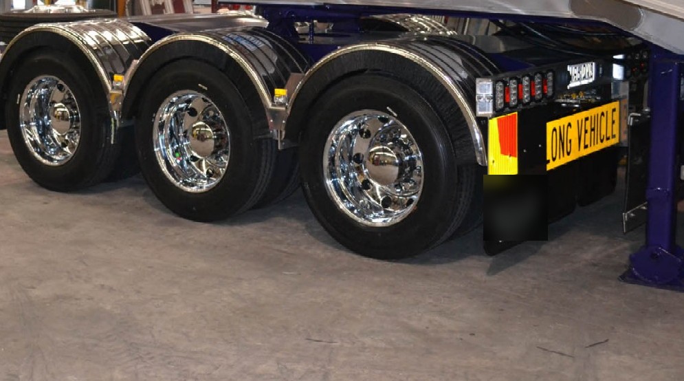 Polished aluminium wheels on a tri-axle trailer